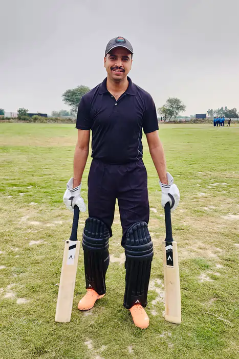 Cricketer with Two ANGLAR Cricket bat in Ground